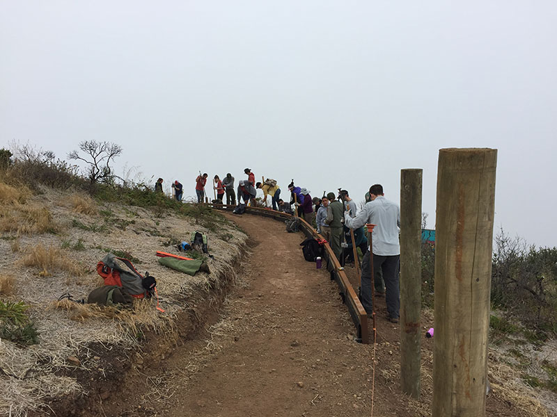 NPS Trail Crew and volunteers install post and cable fencing